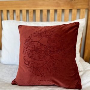 A fabulous rust coloured velvet cushion with a map of Newcastle and Gateshead imprinted on it.