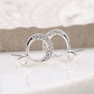 A pair of sterling silver infinity looped stud earrings with crystal studded effect.