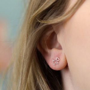 A pair of sterling silver stud earrings that are shaped like a scottie dog.