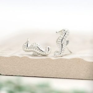 A lovely pair of sterling silver stud earrings that are shaped like seahorses.