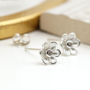 A pair of sterling silver daisy studs with cubic zirconia centre