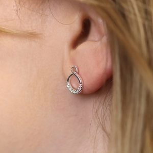 A pair of sterling silver infinity looped stud earrings with crystal studded effect.