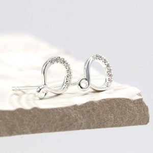 A pair of sterling silver infinity looped stud earrings with crystal studded effect.