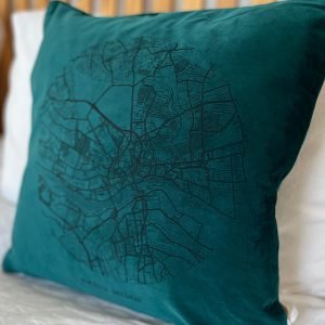 A fabulous teal coloured velvet cushion with a map of Newcastle and Gateshead imprinted on it.