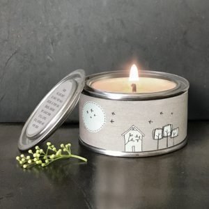 A lovely tin candle with an image of houses around it and the words Those we love don't go away, they walk beside us every day. Unseen, unheard but always near. Still loved, still missed and very dear printed on the label on the lid.