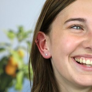 A pair of tiny sterling silver flower studs