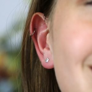 A pair of tiny sterling silver flower studs