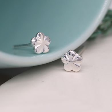 A pair of tiny sterling silver flower studs