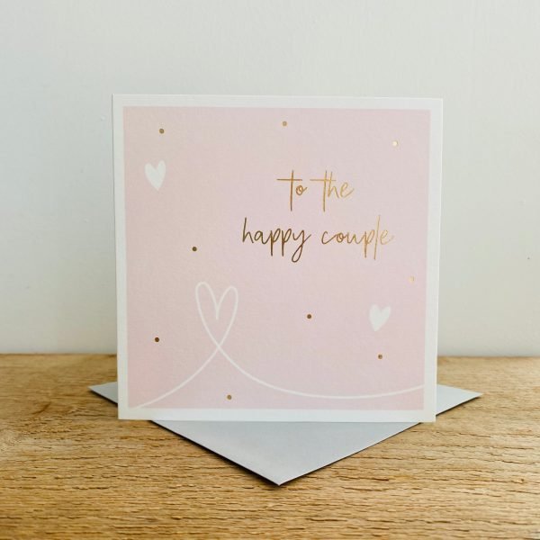 A square Pink card with gold dots and white hearts and the words To The Happy Couple in gold print