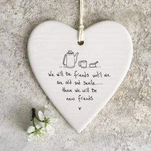 A ceramic hanging heart with the words We will always be friends until we are old and senile... then we will be new friends written on the heart