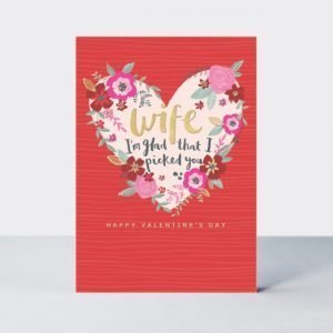 A gorgeous red card with a cream coloured heart in the centre of it and colourful flowers around it. The words Wife I'm glad I picked you are printed in the centre of the heart.