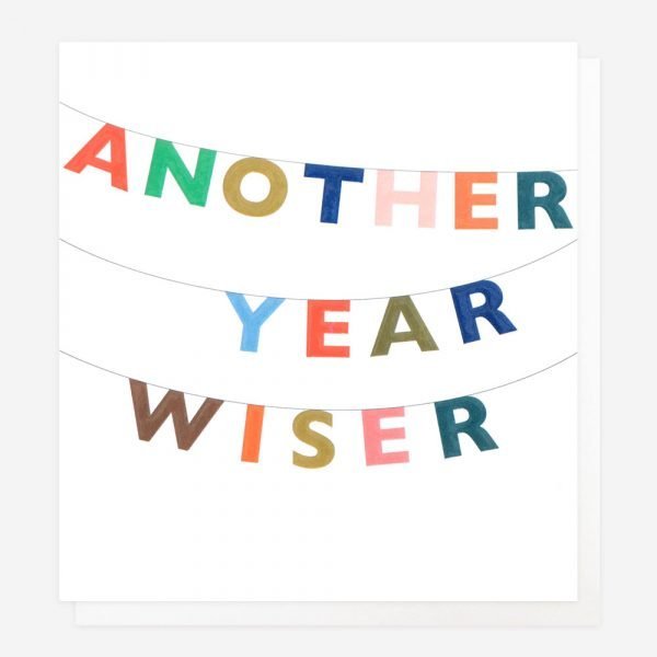 A birthday card with colourful lettering bunting that says "Another Year Wiser"
