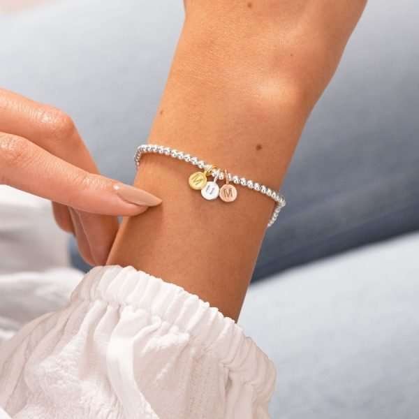 A Little Just For You Mum Joma Bracelet. A silver bracelet with 3 little circular charms in gold rose gold and silver spelling MUM. The bracelet comes presented on a card that reads " A Little Just for you mum. This little bracelet is just for you, because you're my mum and I love you