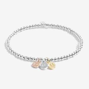 A Little Just For You Mum Joma Bracelet. A silver bracelet with 3 little circular charms in gold rose gold and silver spelling MUM. The bracelet comes presented on a card that reads