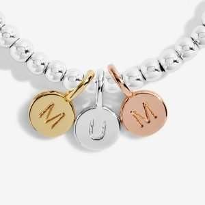 A Little Just For You Mum Joma Bracelet. A silver bracelet with 3 little circular charms in gold rose gold and silver spelling MUM. The bracelet comes presented on a card that reads 