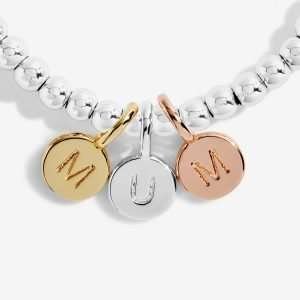 A Little Just For You Mum Joma Bracelet. A silver bracelet with 3 little circular charms in gold rose gold and silver spelling MUM. The bracelet comes presented on a card that reads