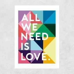 An A3 print with multicoloured geometric background and the words All We Need is Love are printed in white.