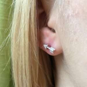 A gorgeous pair of sterling silver arrow stud earrings with cubic zirconia stones encrusted in them.