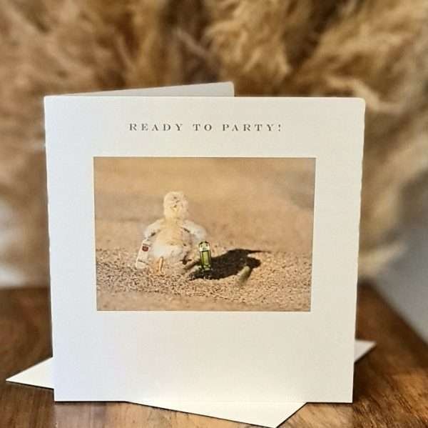 Party Chick Birthday Card. A white card with a photograph of a tiny little chick running away from the calendar with a bottle of gin and a bottle of vodka under its wings. The caption reads "Ready to party!"