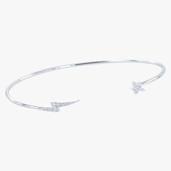A sterling silver cuff bangle with a lightening bolt on one side of the bracelet and a star on the other side. Both lightening bolt and star are covered in tiny cubic zirconia.