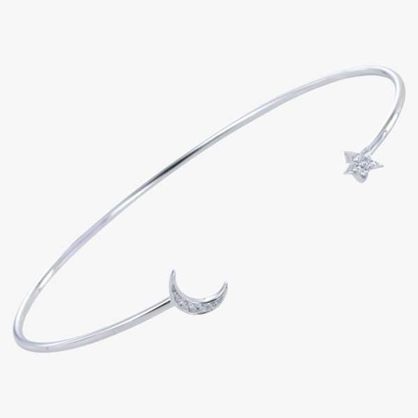 A sterling silver cuff bangle with a lightening bolt on one side of the moon and a star on the other side. Both moon and star are covered in tiny cubic zirconia.