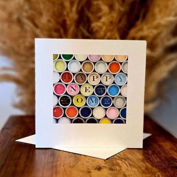 A new home card with a photo of lots of pots of colourful paint and the caption "Happy New Home"