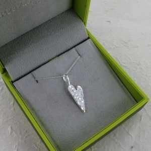 A beautiful long hammered heart pendant on a silver link chain.