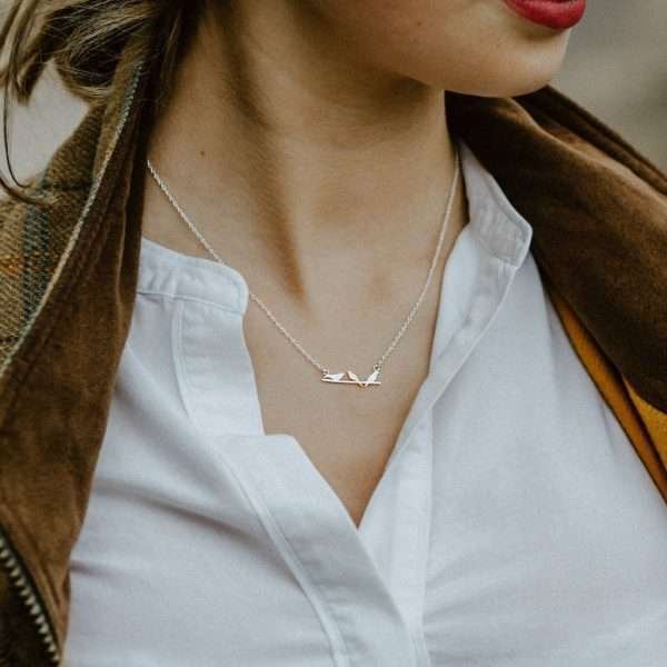 A beautiful Bird on a wire necklace with sterling silver link chain. The three birds are sterling silver with one of the birds detail in gold plating.