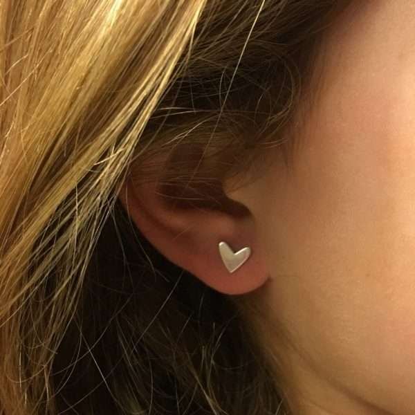 a lovely pair of sterling silver heart shaped cariad stud earrings