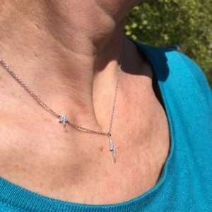 A lovely sterling silver chain link necklace with a lightening pendant which has a star higher up the chain. Bother lightening pendant and the star have a lovely zirconia finish.