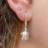 A lovely pair of sterling silver earrings with a turtle design on a drop hook.