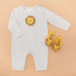 A cotton green and white baby grow with a crochet lion motif