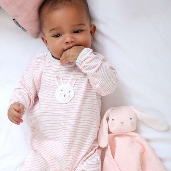A pink and white striped cotton baby grow with grey trim and a crochet rabbit motif