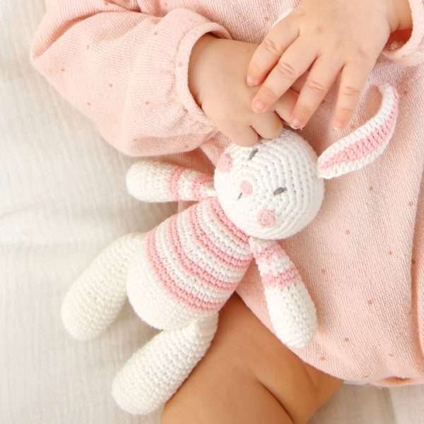 A crochet rabbit toy in white and pink