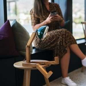 A fun wooden hand made lamp. Made from ash wood with moveable joints and with a vespa style headlamp fixing.