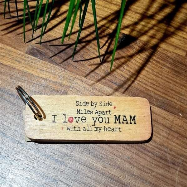 A wooden key ring with side by side or miles apart I love you Mam with all my heart