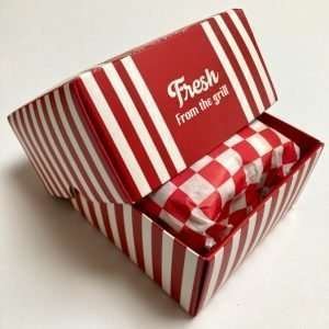 A fun pack of burger themed socks that are presented in a burger box including the wrap paper that burgers come in.