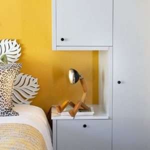 A fun wooden hand made lamp. Made from ash wood with moveable joints and with a vespa style headlamp fixing.