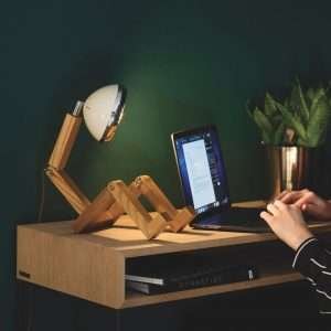 A fun wooden hand made lamp. Made from ash wood with moveable joints and with a vespa style headlamp fixing.