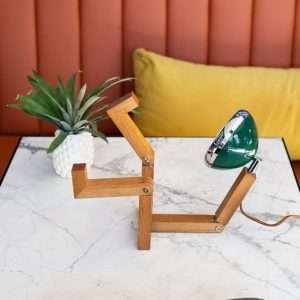 A fun wooden hand made lamp. Made from ash wood with moveable joints and with a vespa style headlamp fixing.