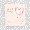 A gorgeous card with a pale pink background and an image of a large heart with confetti and smaller hearts all around it and the words Pearl Wedding Anniversary printed on it.