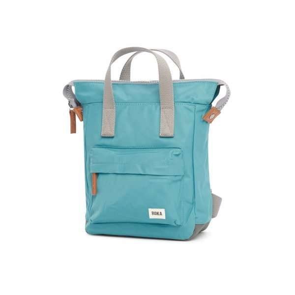 A lovely nylon vegan friendly backpack with a number of pockets in it. The bag has 4 straps on it Two to use as a back pack and two as carry handles. The bag is a lovely petrol blue colour and has vegan leather pullers on the zip.