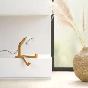 A fun wooden hand made lamp. Made from ash wood with moveable joints and with a vespa style headlamp fixing.