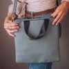 A lovely large blue vegan leather crossbody bag with a short handle and detachable straps