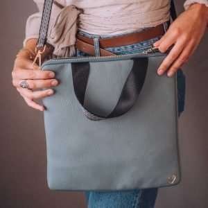 A lovely large blue vegan leather crossbody bag with a short handle and detachable straps