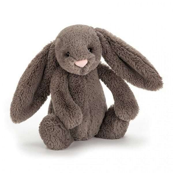 A sweet truffle bunny small from the Bashful range by Jellycat. With mocha coloured fur and a sweet pink nose, truffle bunny has big floppy ears and a cute bobtail.