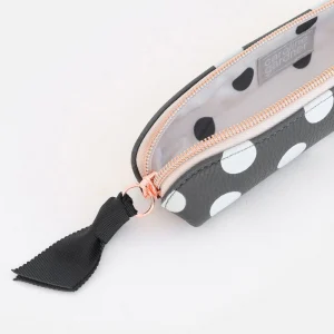 Charcoal Spot Pencil Case. A charcoal grey pencil case with white spots, a contrasting spotty lining and rose gold zip fastening with black grosgrain ribbon zip pull