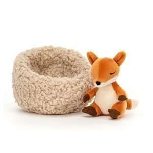 Jellycat Hibernating fox. A little red fox soft toy curled up sleeping in a fluffy nest
