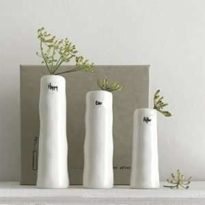 A lovely set of three ceramic bud vases each with a single word on them Happy Ever After. The vases come in a cardboard presentation box with a lid.