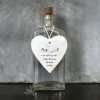 A lovely ceramic white hanging heart with the wording In OUr hearts you will stay, loved and missed every day.